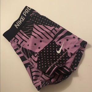 purple and black Nike pros with geometric pattern